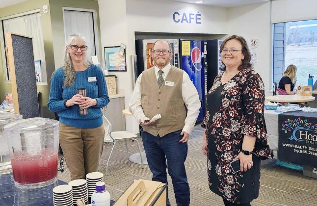 Linda Lewis, Branch Manager of the Greenhorn Valley Library, with Kieran Hixon and Tish Franklish (L-R) from the Pueblo City-County Library greet guests to discuss the new Telehealth Program. Photo by Shirley Pigg